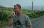Craig on the road back from the China border eating some local fruit